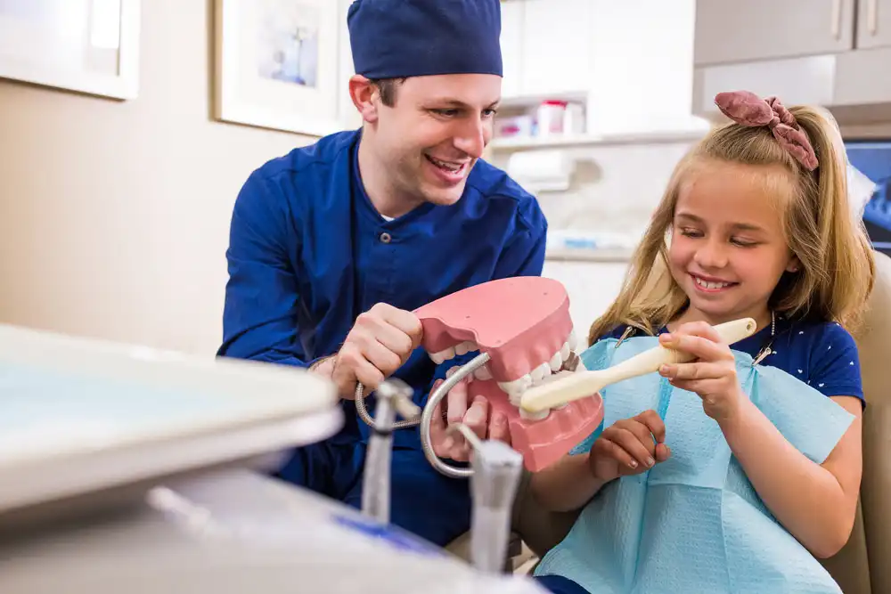Dr Pat Parr showing child how to brush teeth Pediatric Dentistry