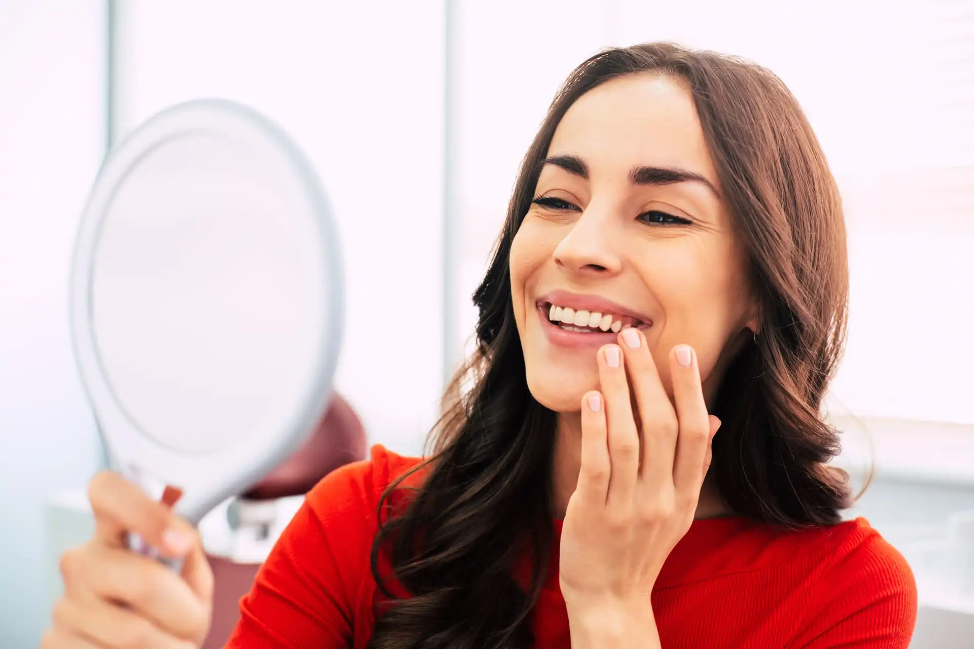 Cosmetic Dentistry woman looking in mirror