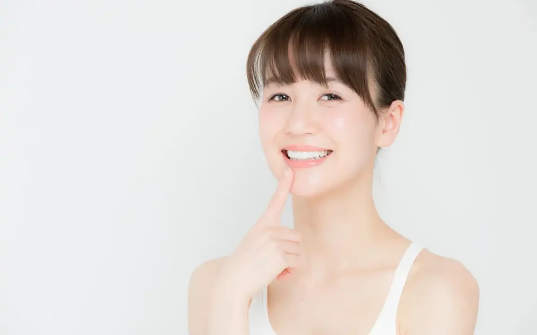 Whiter Teeth Brighter Smiles girl pointing to teeth