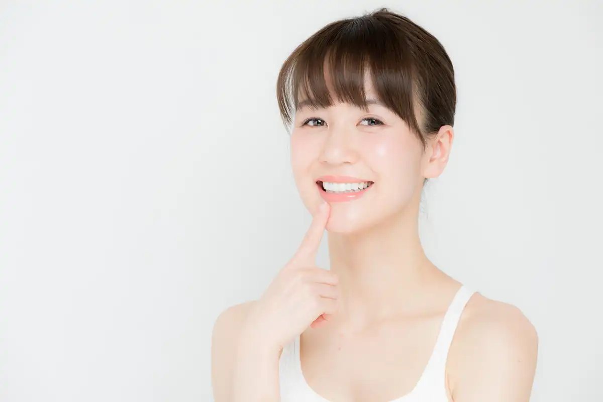 Whiter Teeth Brighter Smiles girl pointing to teeth
