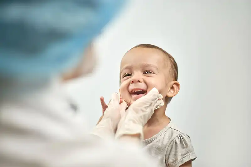 Pediatric-Dentistry-Photo-iStock-1271003997-1 Pediatric Dentistry showing Dr. examining child's cheeks