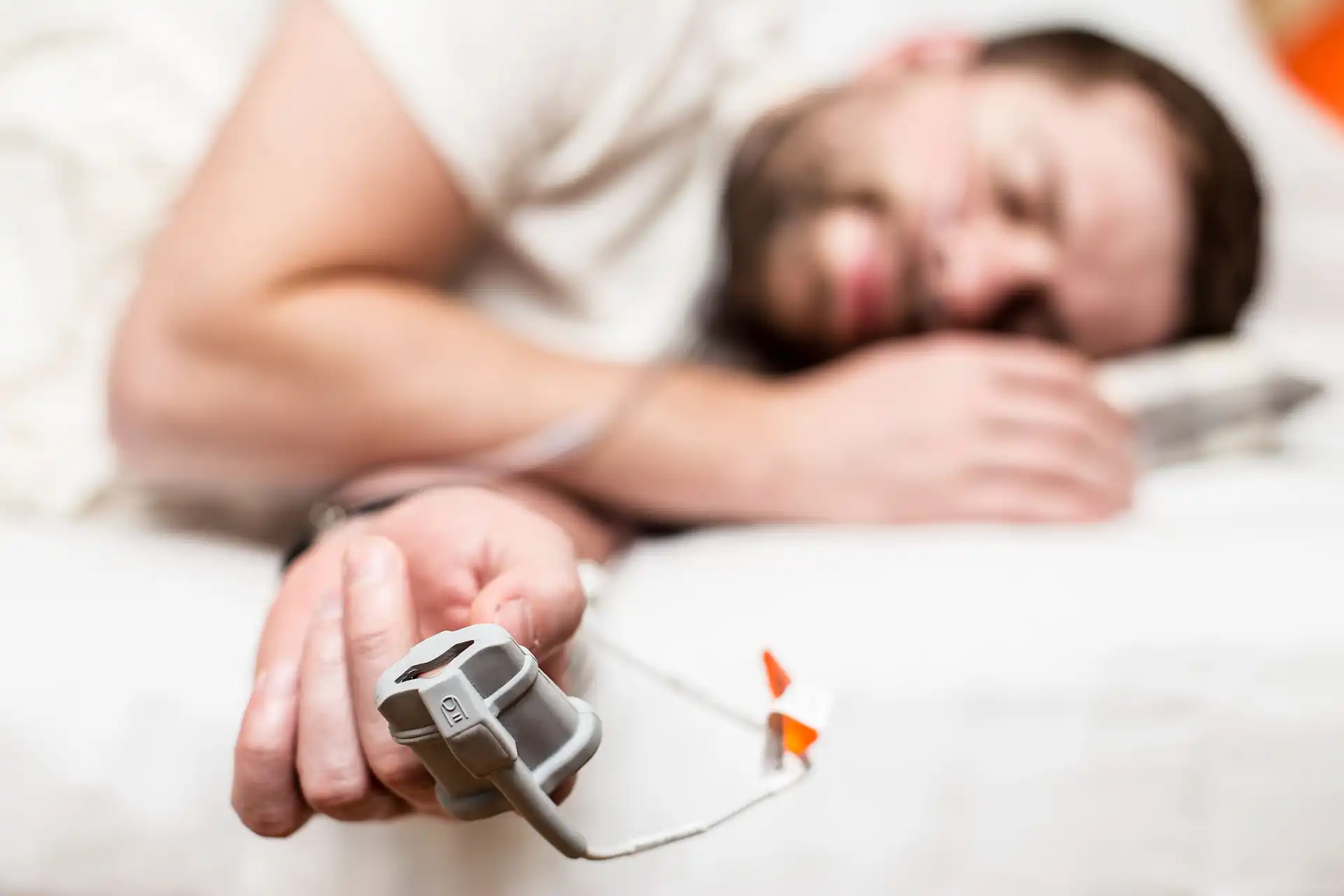 Sleep Apnea device next to man sleeping