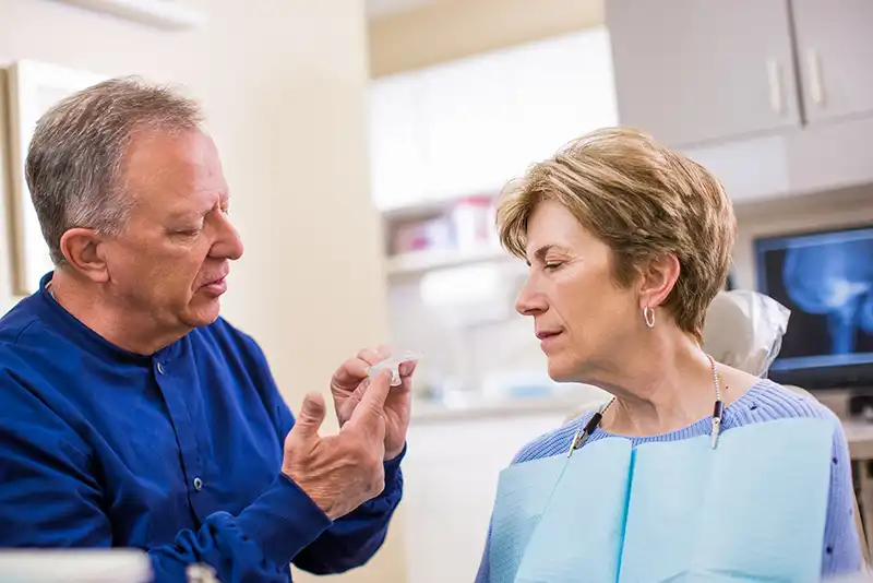 alignment-apparatus-3-1 Dr. william Parr reviewing alignment apparatus with patient for Orthodontics
